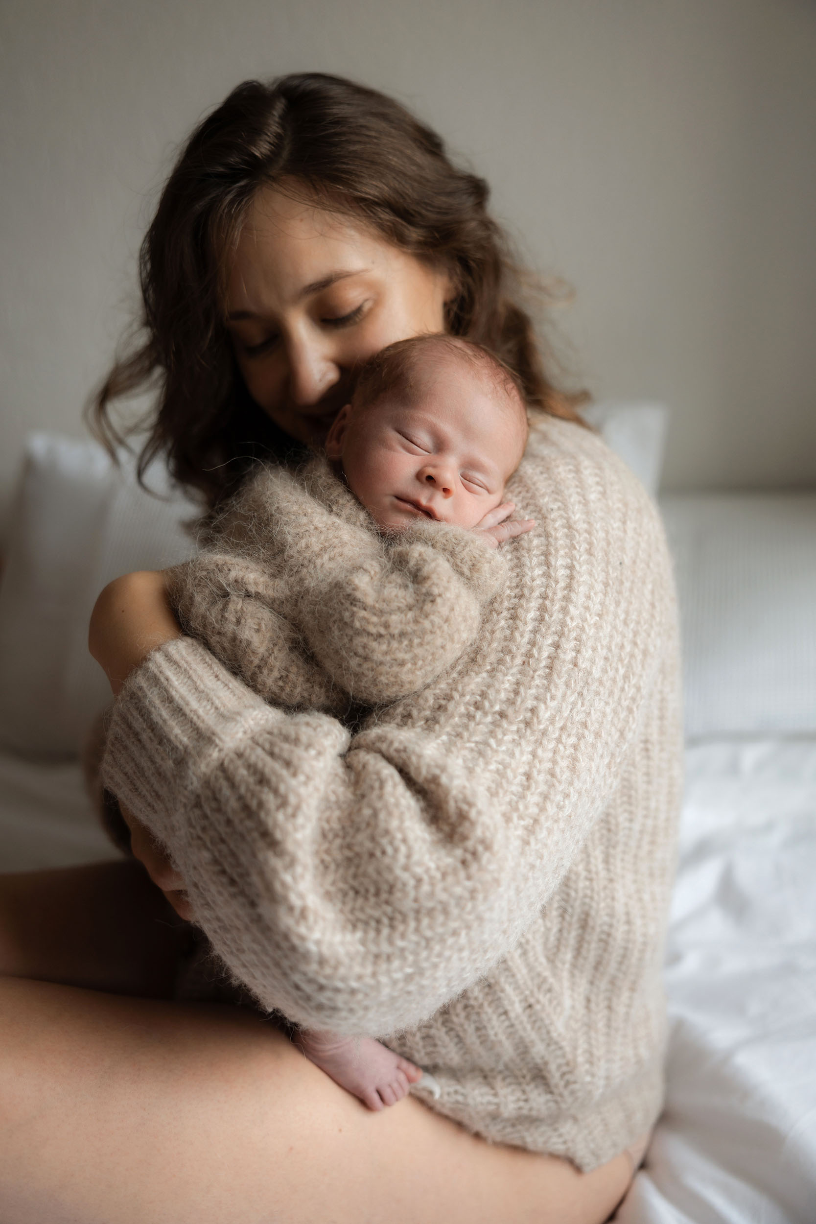 photo of mother and sleeping newborn baby