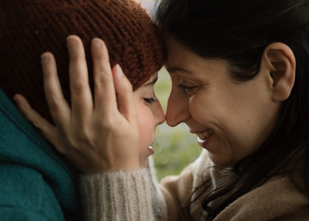 photo of a mother tenderly cradling her son's face